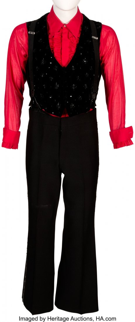 Liberace Stage Worn Three-Piece Costume. A styli: Liberace Stage Worn Three-Piece Costume. A stylish red and black uniform worn by the piano great. The long-sleeve red top has a "L" tag on the interior, next to a tag for Fonzel. Measures 26" sleeve a