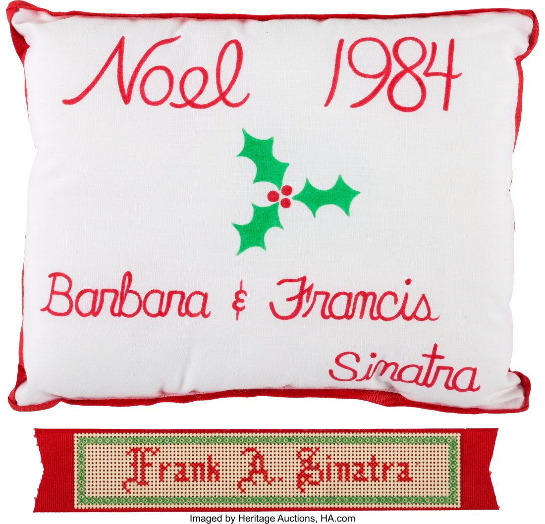 Frank Sinatra Christmas Pillow and Ribbon. Two: Frank Sinatra Christmas Pillow and Ribbon. Two Christmas-themed items from Ol’ Blue Eyes. Lot includes: 1) A small, 7 &frac14;" x 9 &frac12;" pillow with "Noel 1984 / Barbara & Franc