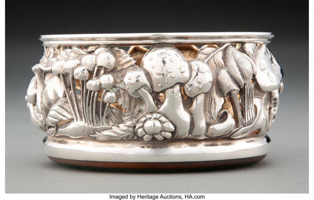 A Robert Butler Mushroom Silver and Hardwood Win: A Robert Butler Mushroom Silver and Hardwood Wine Coaster, late 20th century Marks: RAB, STERLING 2-3/4 x 5-1/2 inches (7.0 x 14.0 cm) 21 ounces (gross) Property from the Collection of Dr. James Young