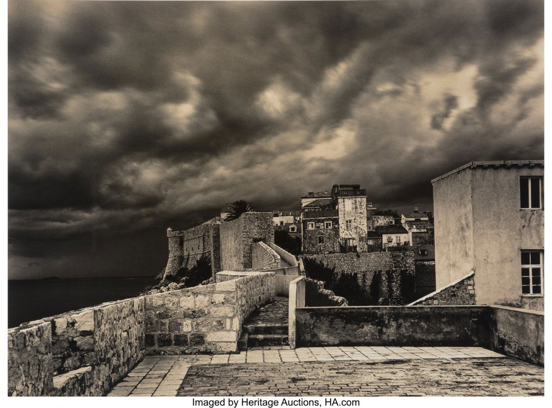 Roman Loranc (Polish/American, 1956) Dark Clouds: Roman Loranc (Polish/American, 1956) Dark Clouds Over Dubrovnik, 2009 Toned gelatin silver print 14 x 19 inches (35.6 x 48.3 cm) Signed in pencil, mount recto. Editioned 23/40, label verso. PROVENANCE