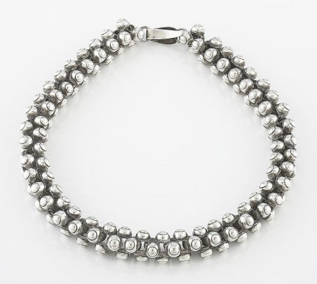 A MEXICAN BEADED SILVER NECKLACE In the style of: A MEXICAN BEADED SILVER NECKLACE In the style of William Spratling, Taxco, Mexico, circa 19