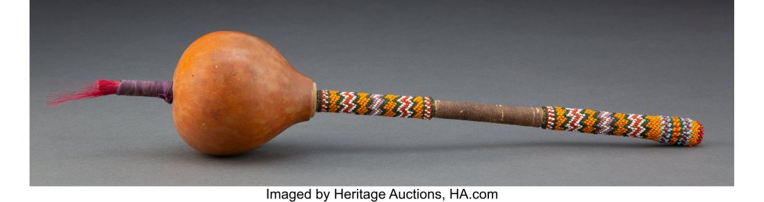 A Kiowa Gourd Rattle Height: 15 inches overall: A Kiowa Gourd Rattle Height: 15 inches overall HID03101062020 © 2022 Heritage Auctions | All Rights Reserved