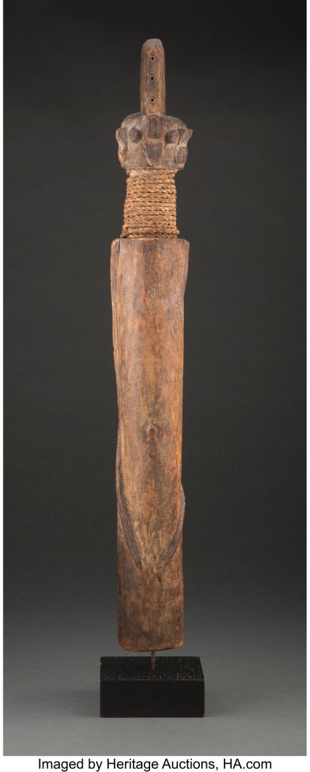 A Wurkun Male Figure, kundul Northern Nigeria, : A Wurkun Male Figure, kundul Northern Nigeria, c. 20th century Carved wood with a brown stain, palm frond rope wrapping the neck. Of typical highly abstract form,