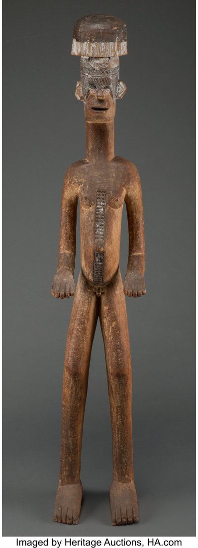 A Large Igbo Shrine Figure, Alusi Nigeria, earl: A Large Igbo Shrine Figure, Alusi Nigeria, early to mid 20th century Carved from dense hardwood, the male stands on two large feet, legs and arms flexed with palms facing forwa