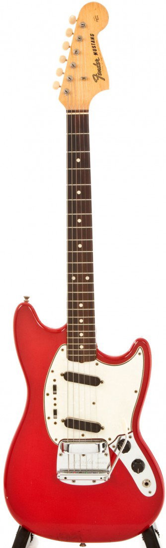 1965 Fender Mustang Red Electric Guitar, #L89009: 1965 Fender Mustang Red Electric Guitar, #L89009. Moderate weather checking. Dings, scrap