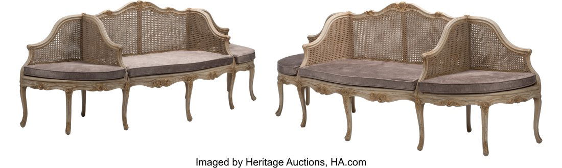 A Pair of French Louis XV-Style Painted and Part: A Pair of French Louis XV-Style Painted and Partial Gilt Cane Settees 41-1/2 x 102 x 30 inches (105.4 x 259.1 x 76.2 cm) (each) The settees, with sea