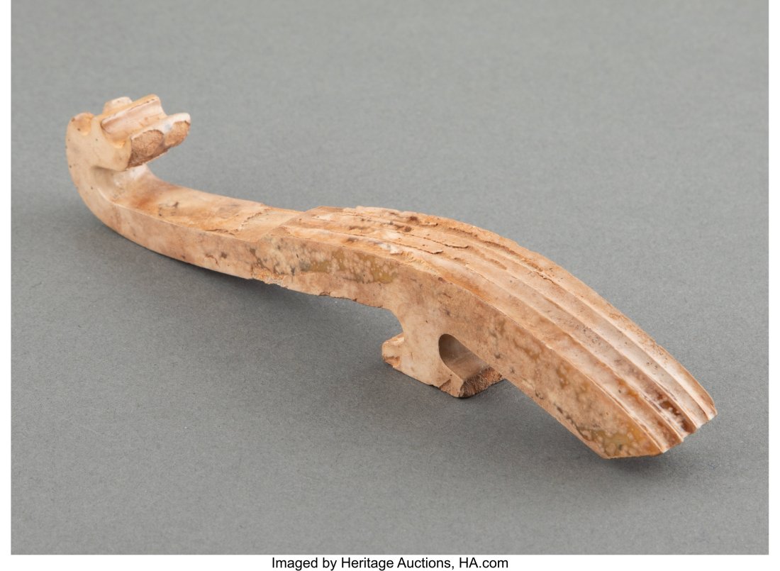 A Chinese Archaic Jade Belt Hook 6-1/4 x 1 x 0-7: A Chinese Archaic Jade Belt Hook 6-1/4 x 1 x 0-7/8 inches (15.9 x 2.5 x 2.2 cm) HID03101062020 © 2022 Heritage Auction