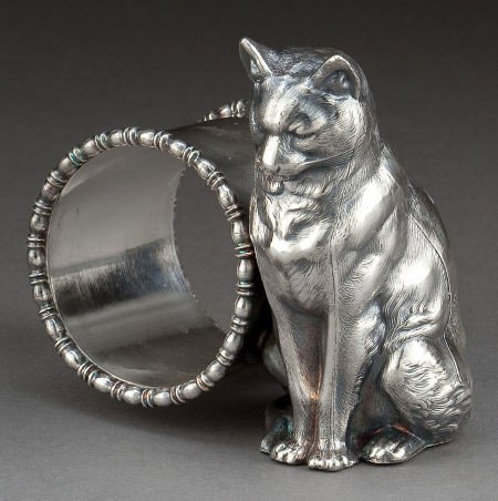 AN AMERICAN SILVER-PLATED FIGURAL NAPKIN RING A: AN AMERICAN SILVER-PLATED FIGURAL NAPKIN RING Attributed to Meriden Britannia Company