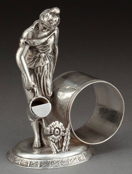 A SIMPSON, HALL, MILLER SILVER-PLATED FIGURAL NA: A SIMPSON, HALL, MILLER SILVER-PLATED FIGURAL NAPKIN RING Simpson, Hall, Miller & Co.