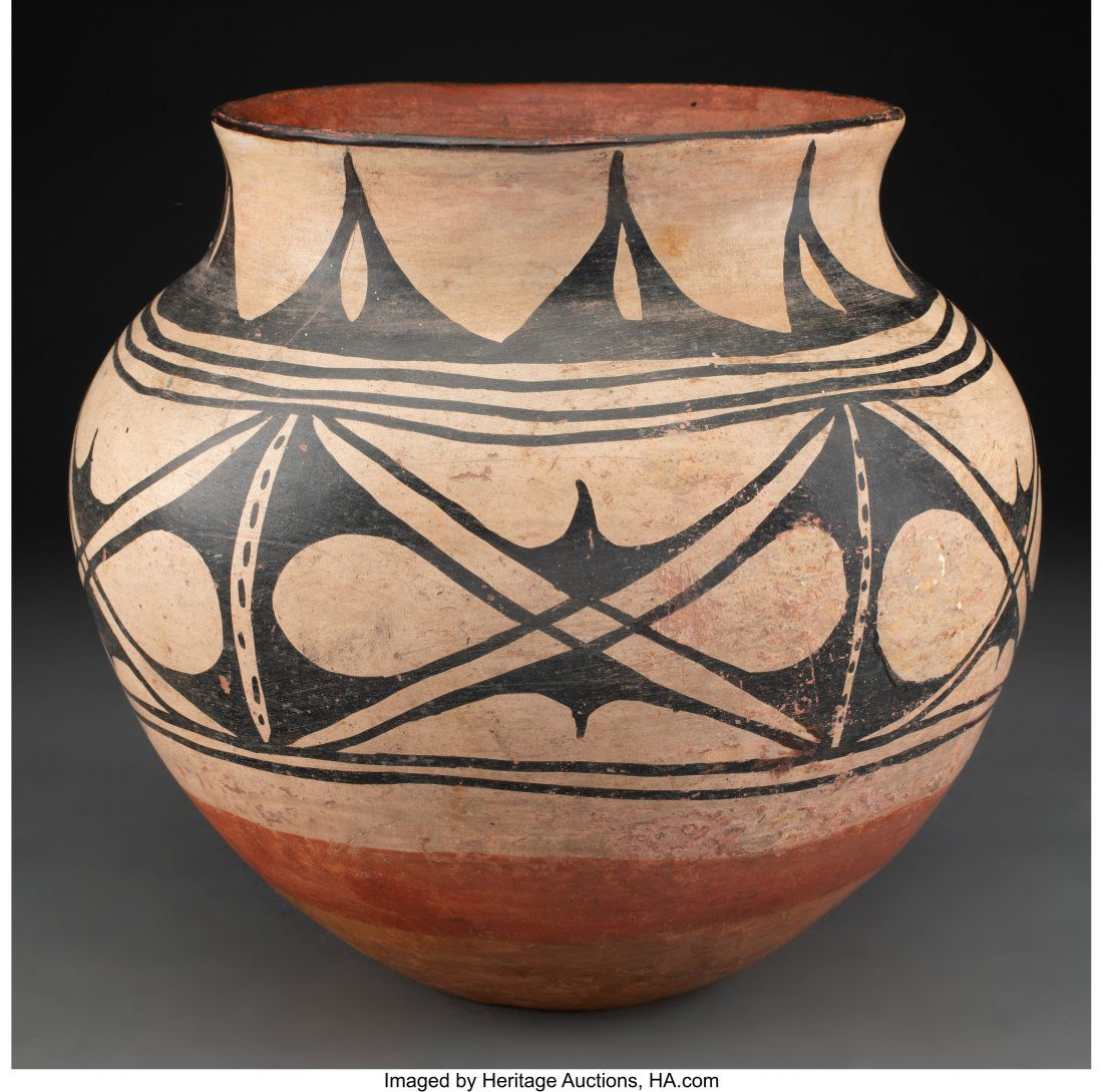 A Santo Domingo Polychrome Jar   c. 1920  clay, (1 of 2)