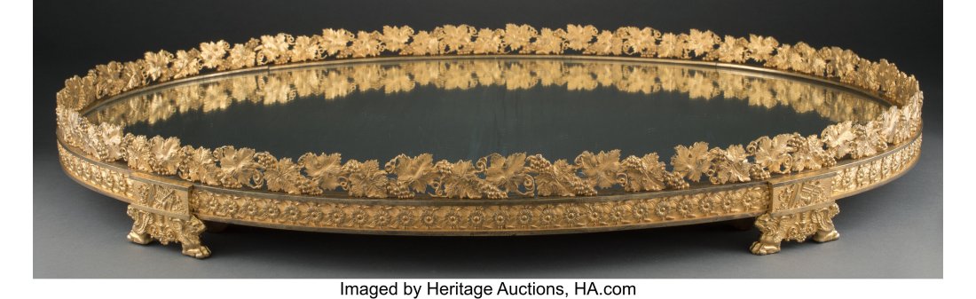 An Empire-Style Gilt Bronze Mirrored Surtout de : An Empire-Style Gilt Bronze Mirrored Surtout de Table, early 20th century 3-7/8 x 32-1/2 x 23 inches (9.8 x 82.6 x 58.4 cm) Property from a Palm Beach Coll