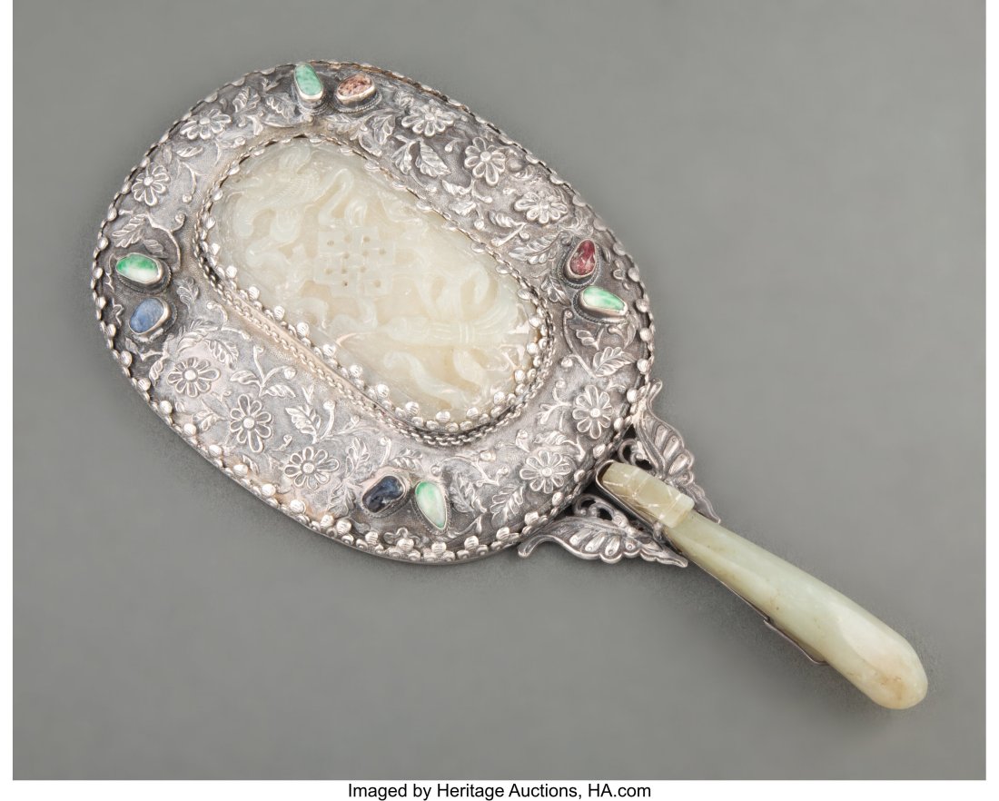 A Chinese Silver Mirror with Carved Hardstone In: A Chinese Silver Mirror with Carved Hardstone Inlay 9 x 4-3/8 x 1 inches (22.9 x 11.0 x 2.5 cm) HID03101062020 © 2022 Heri
