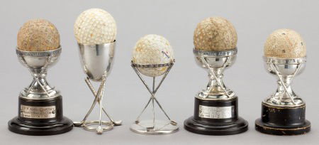 FIVE ENGLISH SILVER HOLE-IN-ONE TROPHIES AND GOL: FIVE ENGLISH SILVER HOLE-IN-ONE TROPHIES AND GOLF BALLS 20th century Marks: (lion