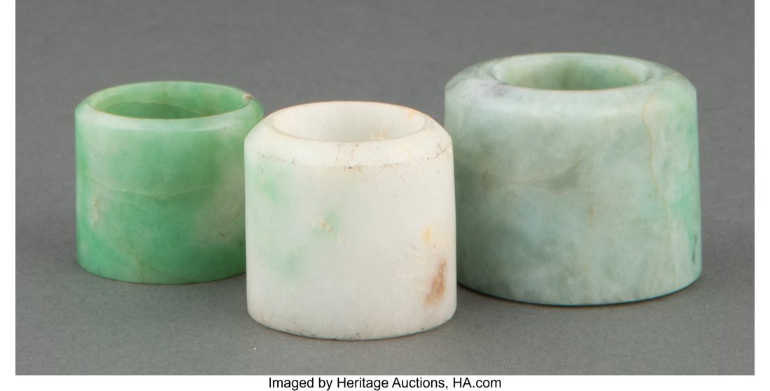 A Group of Three Chinese Jadeite Archer's Rings: A Group of Three Chinese Jadeite Archer's Rings 1-1/8 x 1-3/8 x 1-3/8 inches (2.9 x 3.5 x 3.5 cm) (largest) HID03101062020 © 2022 Heritage Auc