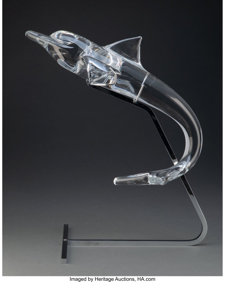 A Daum Glass Dolphin on Chromed Metal Stand Mark: A Daum Glass Dolphin on Chromed Metal Stand Marks: Daum France 17 x 6-1/2 x 6-1/2 inches (43.2 x 16.5 x 16.5 cm) (dolphin) 10-3/4 x 15-5/