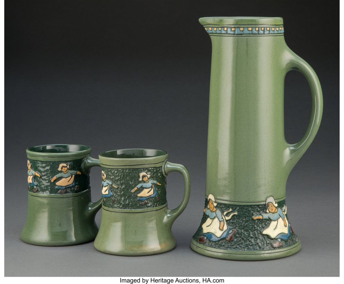 Roseville Della Robbia Pottery Dutch Girls Pitch: Roseville Della Robbia Pottery Dutch Girls Pitcher and Pair of Mugs, circa 1910 Marks to pitcher: HL 10-1/2 inches (26.7 cm) (tallest, pitcher) Property from the Collection of a Florida Antique Dealer
