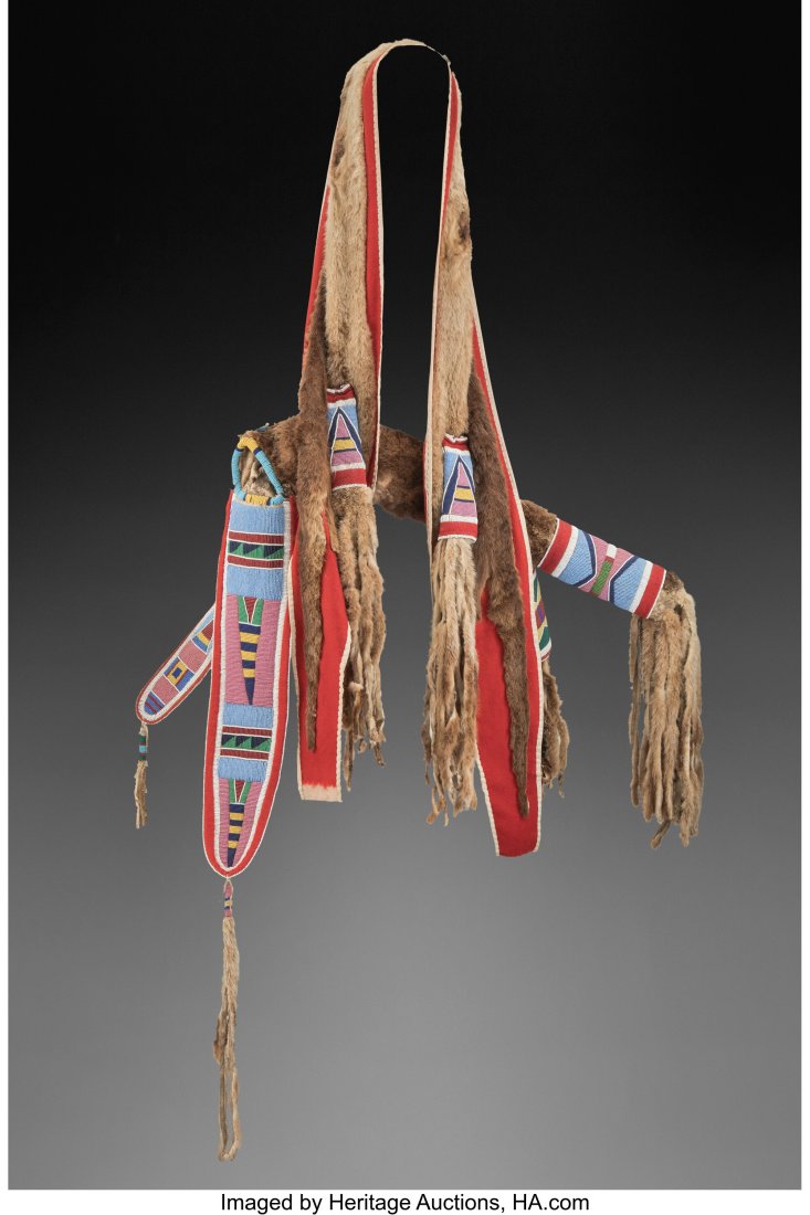 A Crow / Nez Perce Otter Skin Bow Case and Quive: A Crow / Nez Perce Otter Skin Bow Case and Quiver c. 1880 otter skin, red wool trade cloth, cotton cloth, muslin, hide, glass seed beads In a letter dated Febr