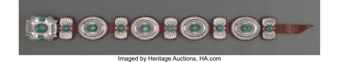 A Navajo Concho Belt c. 1985 stamped KS, Ster: A Navajo Concho Belt c. 1985 stamped KS, Sterling, silver, turquoise, commercial leather Lengths: overall, 46 inches; conchos, 4 &frac12;