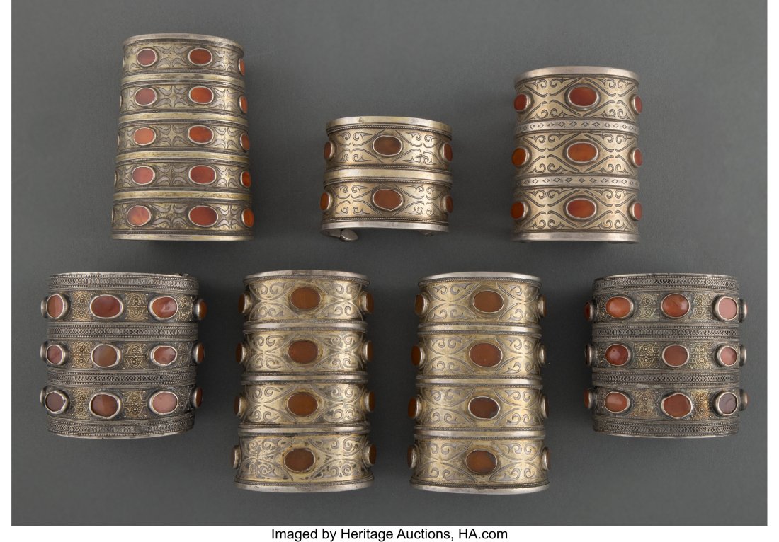Seven Trukmen Cuff Bracelets, bilezik Turkmenis: Seven Trukmen Cuff Bracelets, bilezik Turkmenistan / Central Asia, c. 19th to early 20th century Each silver with gold over the bands, each with carnelian inlay. Pr