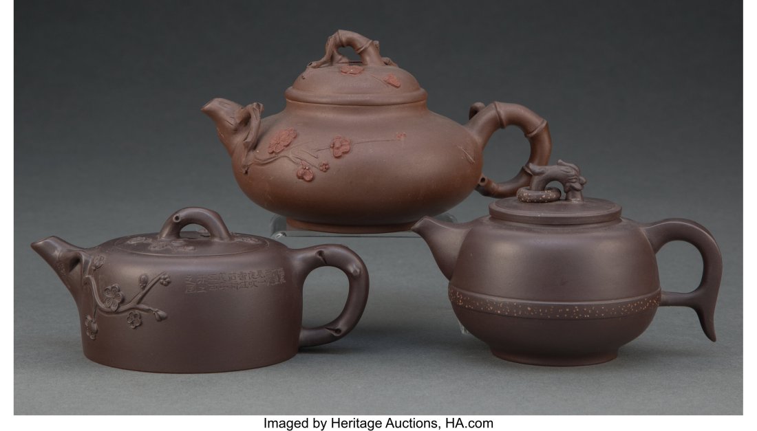 A Group of Three Chinese Yixing Teapots Marks: f: A Group of Three Chinese Yixing Teapots Marks: four-character mark (each) 3-5/8 x 5-7/8 x 4-1/2 inches (9.2 x 14.9 x 11.4 cm) (largest&r