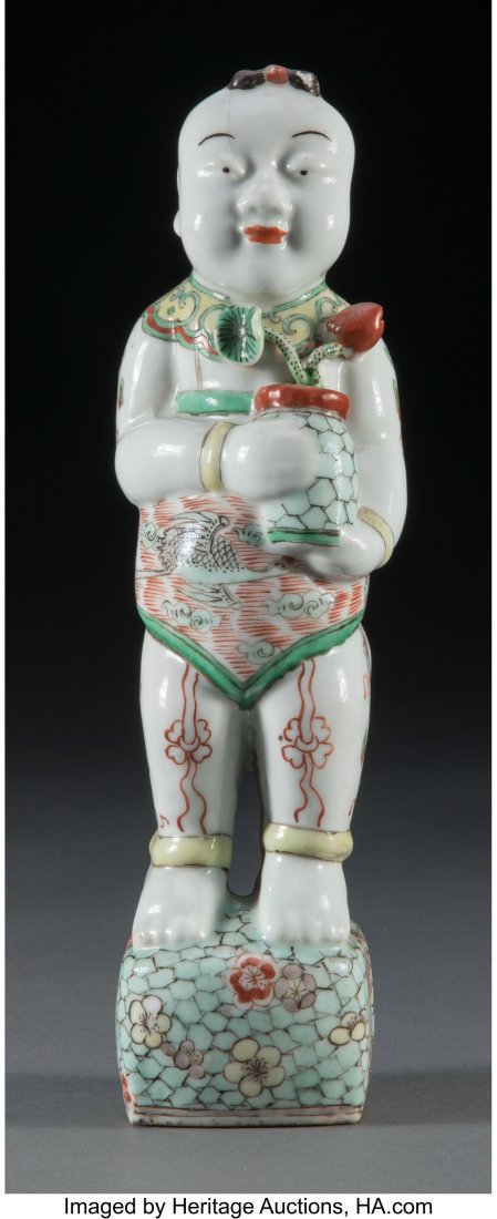 A Chinese Famille Verte Figure, Qing Dynasty 10-: A Chinese Famille Verte Figure, Qing Dynasty 10-5/8 x 3 x 3-1/4 inches (27.0 x 7.6 x 8.3 cm) Presenting a boy holding a vase with lotus bud and leaf,