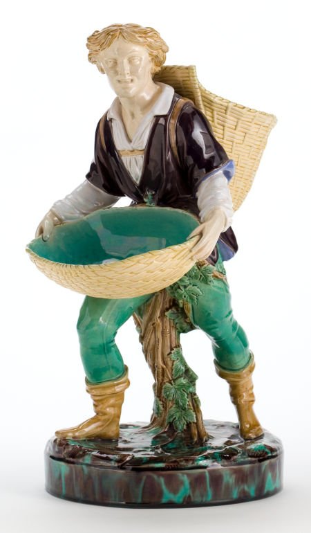 A MINTON MAJOLICA FIGURE VINTAGER SWEET-MEAT DIS: A MINTON MAJOLICA FIGURE VINTAGER SWEET-MEAT DISH <