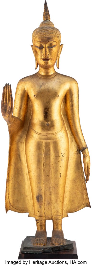 A Large Thai Carved Gilt Wood Standing Buddha Fi: A Large Thai Carved Gilt Wood Standing Buddha Figure 43 x 15-3/4 x 10 inches (109.2 x 40.0 x 25.4 cm) (figure) HID03101062020 © 2024 Heritage Auctions
