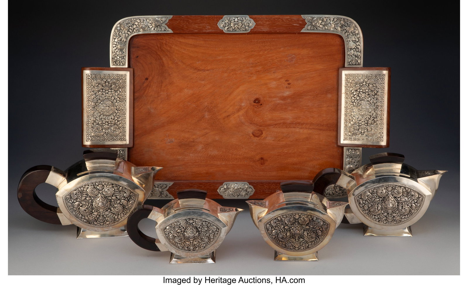 A Five-Piece Cambodian Silver Tea Set Accompanie: A Five-Piece Cambodian Silver Tea Set Accompanied by Fitted Case 1-3/4 x 23 x 13-7/8 inches (4.4 x 58.4 x 35.2 cm) (largest, tray) 4200 grams &lp