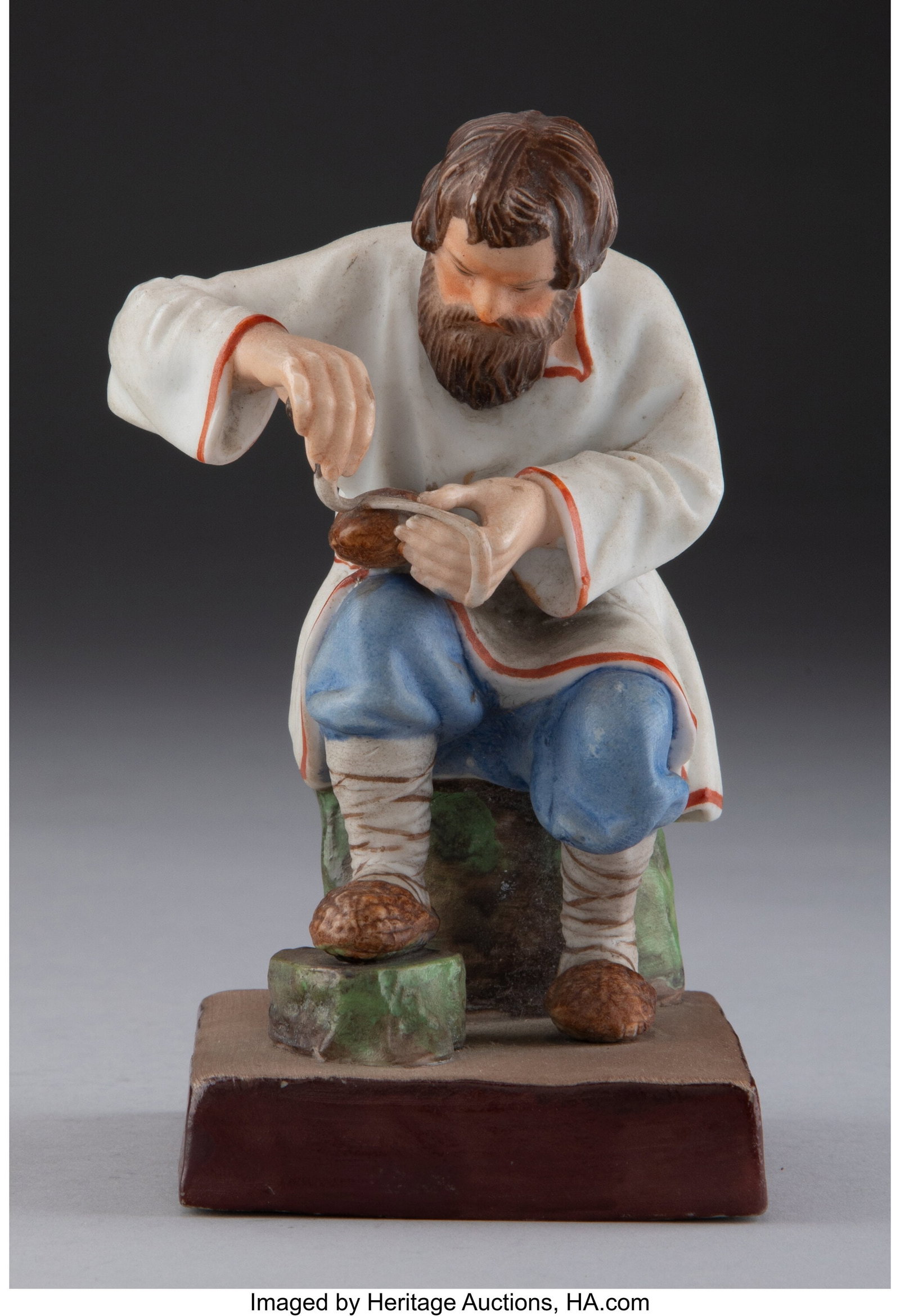 A Gardner Porcelain Factory Figure: Bast Shoe Ma: A Gardner Porcelain Factory Figure: Bast Shoe Maker, Verbilki, late 19th century Marks: (red underglaze Gardner factory mark), (impressed factory mark), (impressed Cyrillic text), 231 5 x 3 x 3-1/2 in
