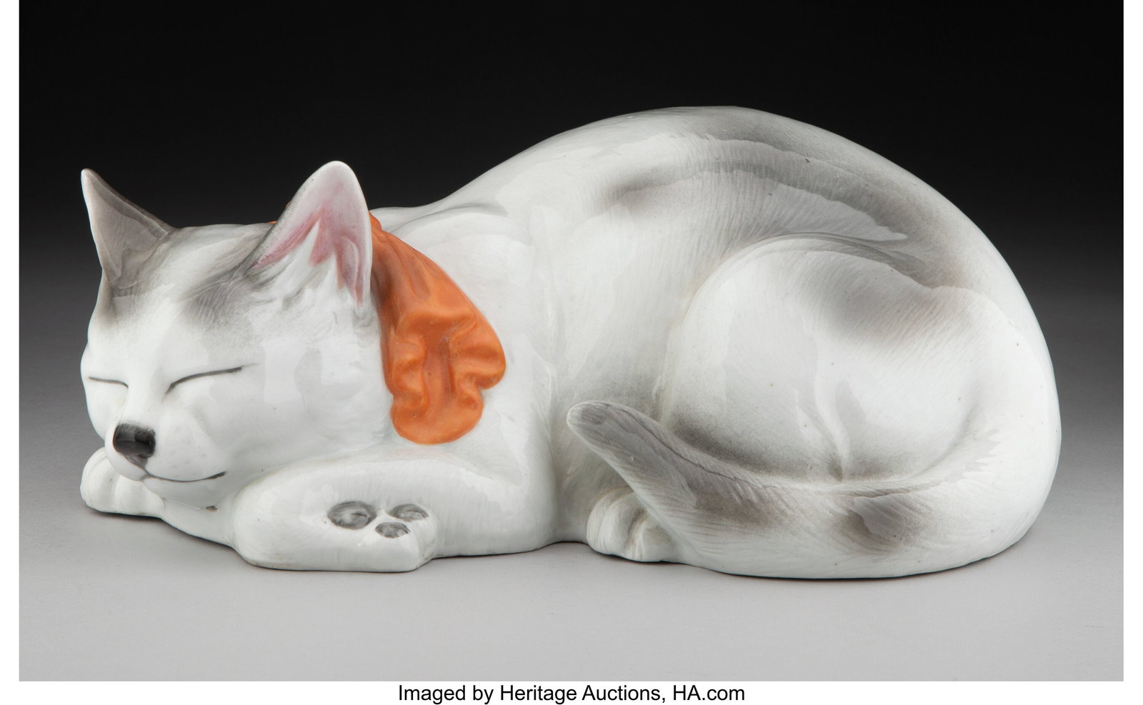 A Japanese Kutani Porcelain Sleeping Cat Figure,: A Japanese Kutani Porcelain Sleeping Cat Figure, Meiji Period 4-3/4 x 12-1/2 x 8 inches (12.1 x 31.8 x 20.3 cm) Property from the Nelkin Collection HID0310