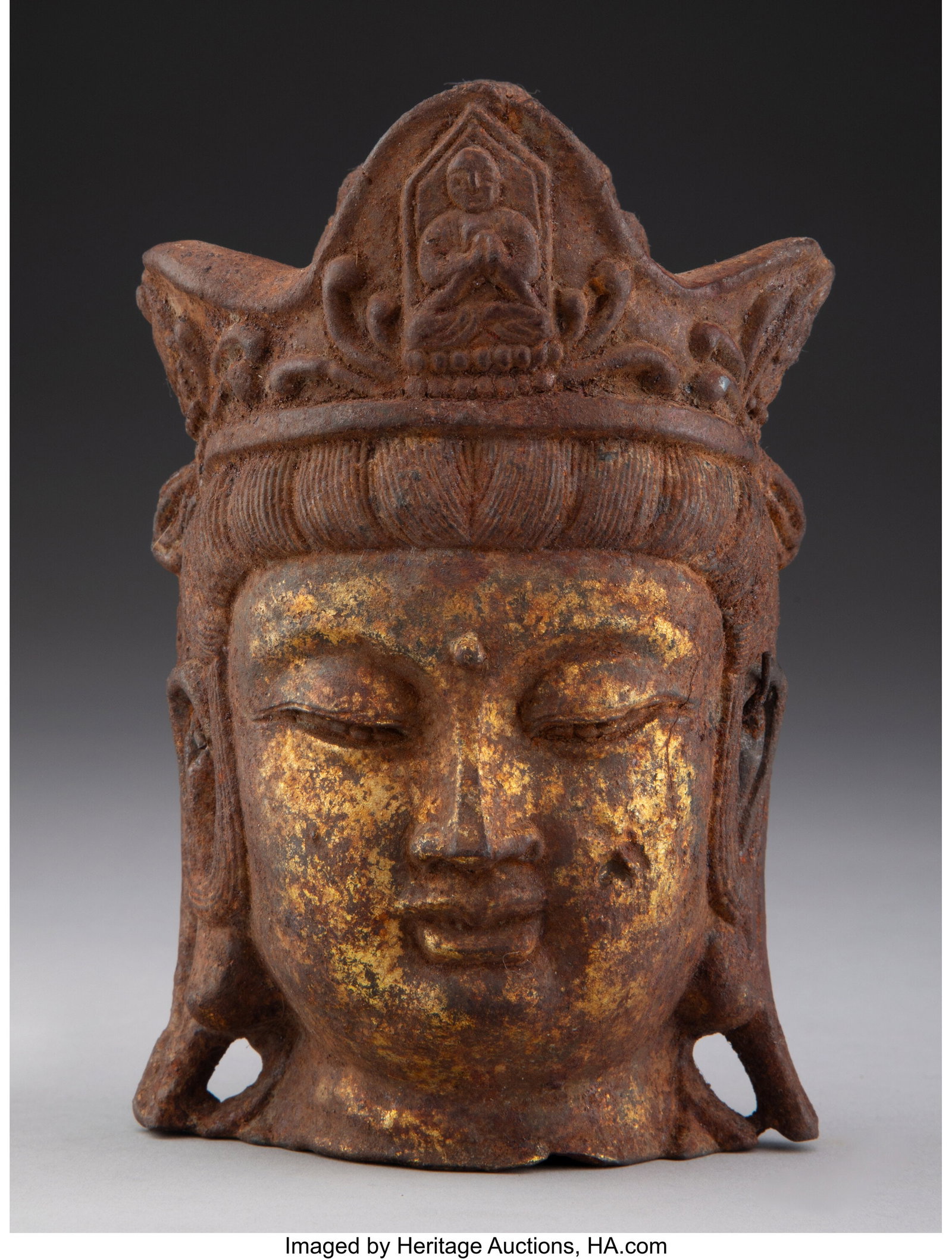 A Gilt Metal Stone Head 6 x 3-3/4 x 2-3/4 inches: A Gilt Metal Stone Head 6 x 3-3/4 x 2-3/4 inches (15.2 x 9.5 x 7.0 cm) Collection of Jonathan Kern to Benefit Charity HID03101062020 © 2024 Heritage Auction