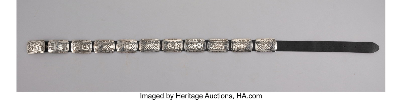 A Navajo Concho Belt c. 2000 hallmarked and s: A Navajo Concho Belt c. 2000 hallmarked and stamped Sterling, silver, copper Lengths: overall, 49 inches, conchos 3 inches each HID03101062020 © 2024 Heritage