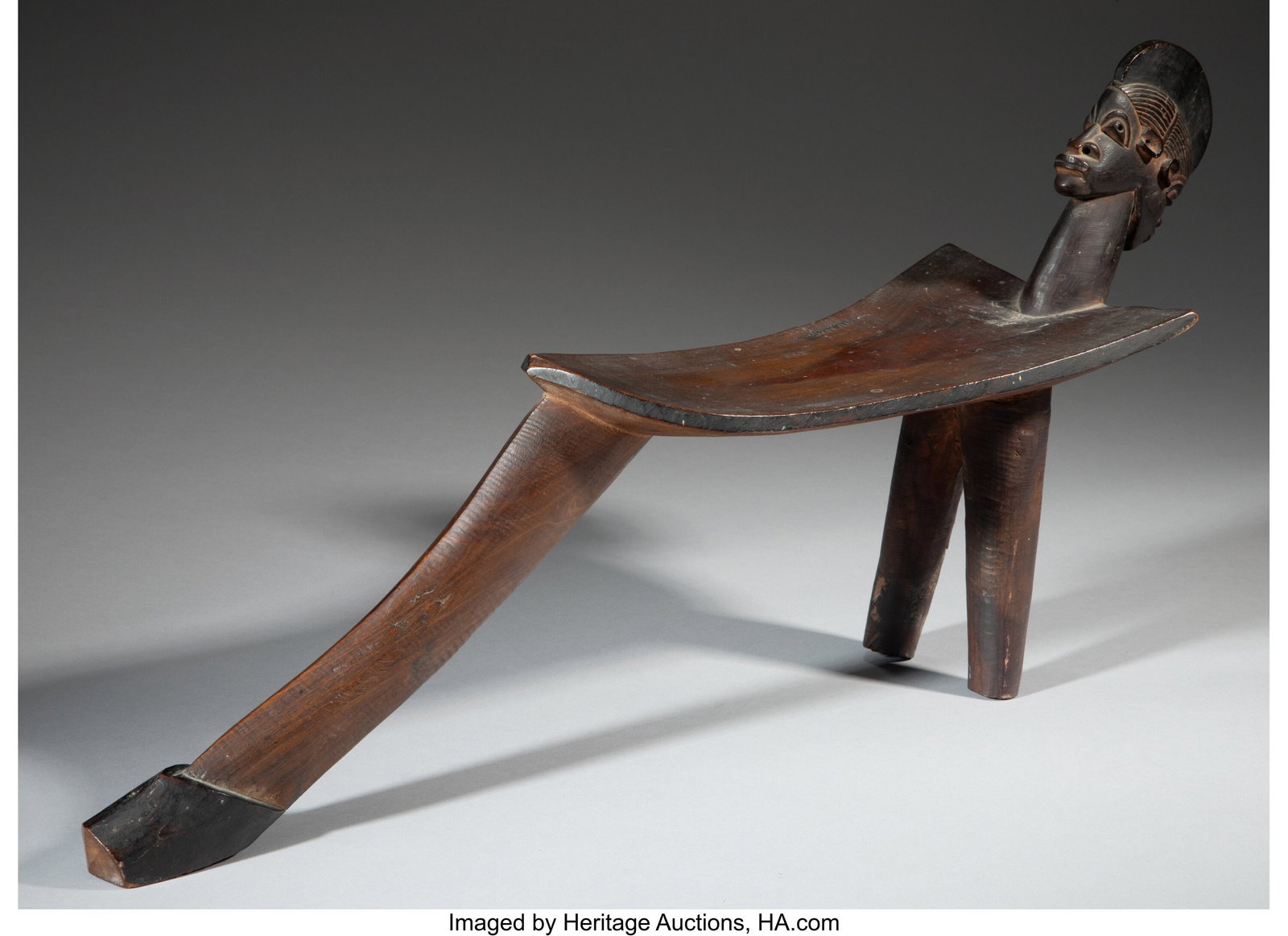 A Lobi Stool, daak Burkina Faso, c. early 20th : A Lobi Stool, daak Burkina Faso, c. early 20th century Carved in the manner of Sikire Kambire (1896-1963). Janus heads raised up at one end. The wood with a 