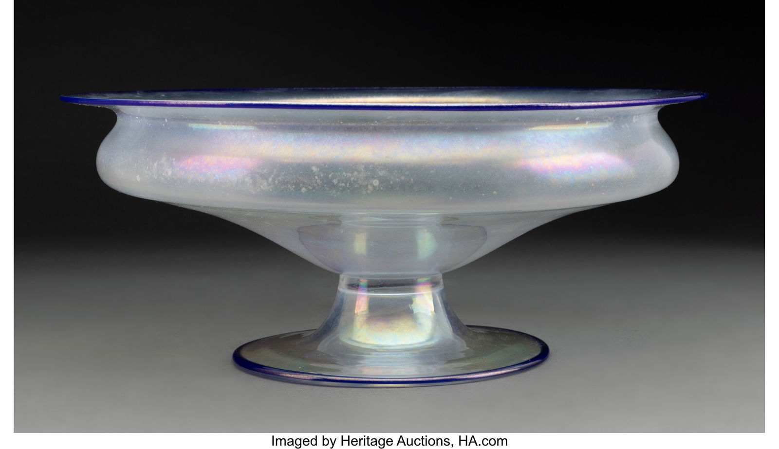 Steuben Glass Works Footed Bowl, circa 1920 USA: Steuben Glass Works Footed Bowl, circa 1920 USA Verre de Soie glass with blue trim 4-3/4 x 11-5/8 inches (12.1 x 29.5 cm) HID03101062020 © 2024 Heritage Auct