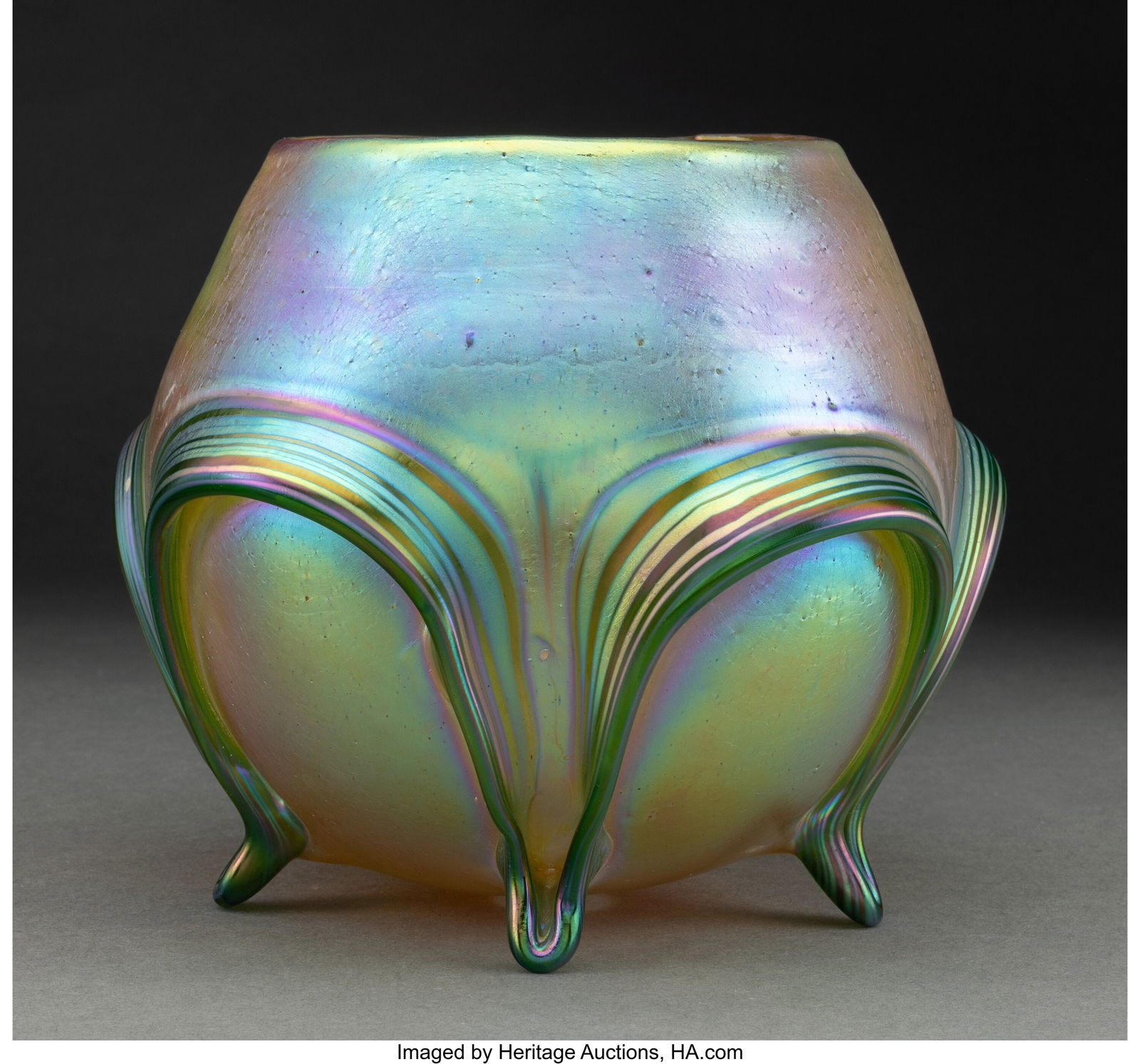 Loetz Footed Vase, circa 1900 Silberiris Candi: Loetz Footed Vase, circa 1900 Silberiris Candia and Crete glass 6-1/2 x 7-3/4 inches (16.5 x 19.7 cm) HID03101062020 © 2024 Heritage Auctions | All Righ