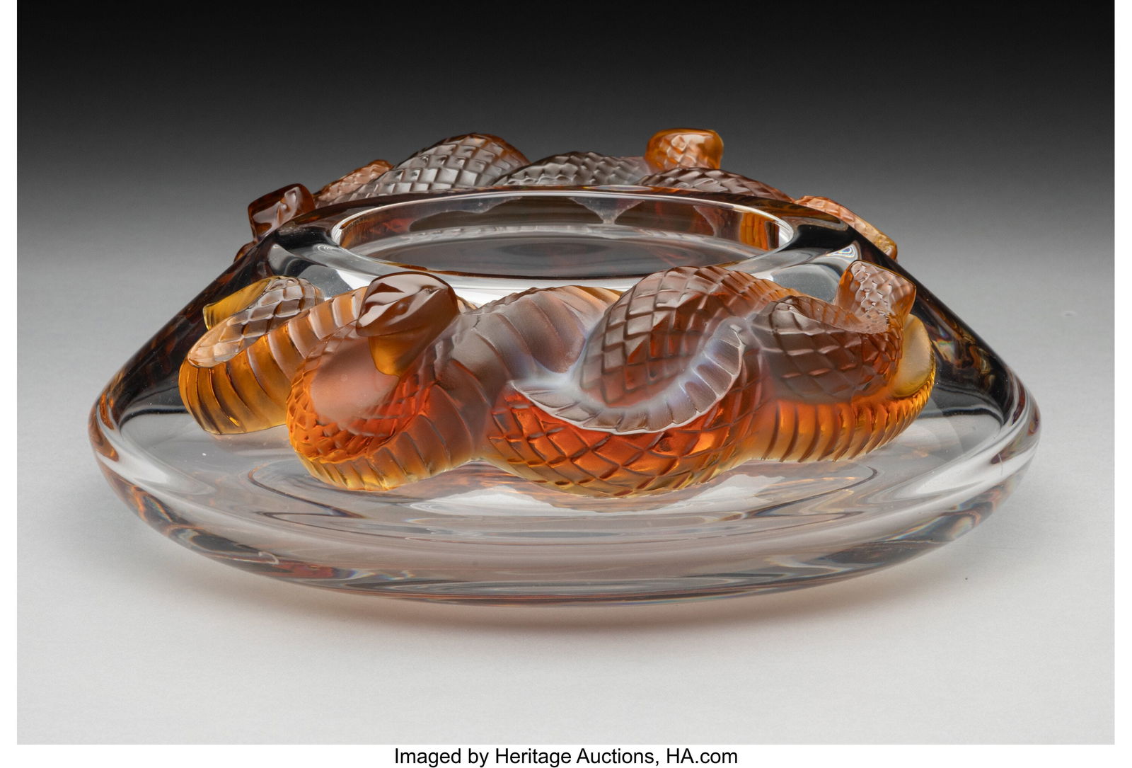 Lalique Serpent Bowl, post-1945 France Clear an: Lalique Serpent Bowl, post-1945 France Clear and amber glass 3 x 9-1/4 x 8-1/4 inches (7.6 x 23.5 x 21.0 cm) Marks: Lalique France Property from a Pr
