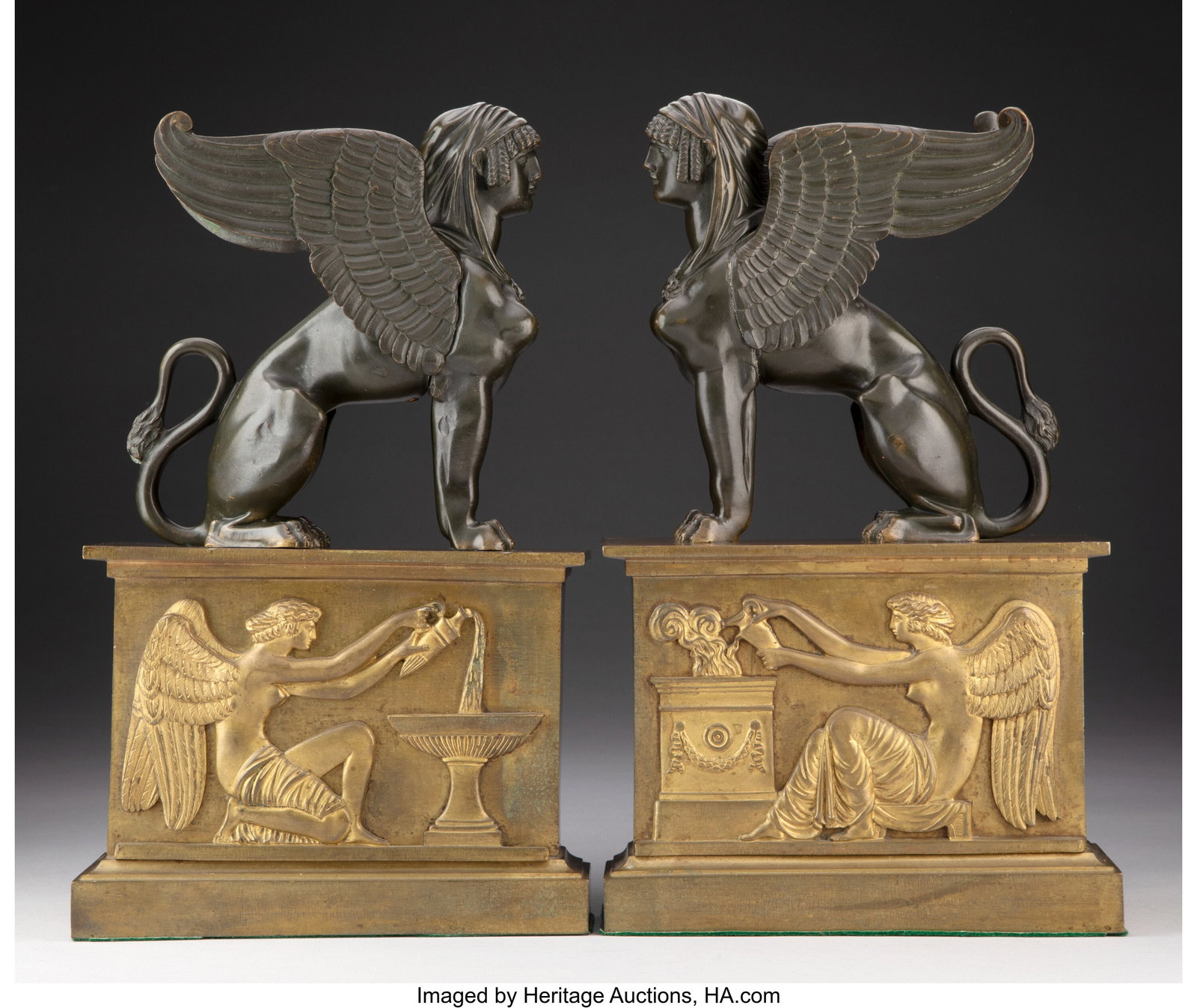 A Pair of Bouhon Frères Egyptian-Revival Gilt a: A Pair of Bouhon Frères Egyptian-Revival Gilt and Patinated Bronze Chenets, late 19th century Marks: BOUHON FRES 14-1/4 x 8-5/8 x 4 inches (36.2 x 21.9 x 