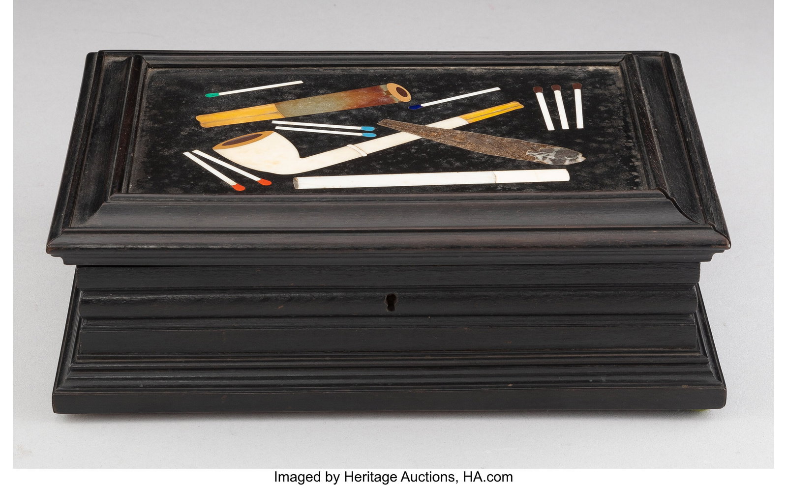 An Italian Carved Ebonized Wood Cigar Box with P: An Italian Carved Ebonized Wood Cigar Box with Pietra Dura Inset Cover, early 20th century 2-1/2 x 8 x 5-3/4 inches (6.3 x 20.3 x 14.6 cm) PROVENANCE&colon