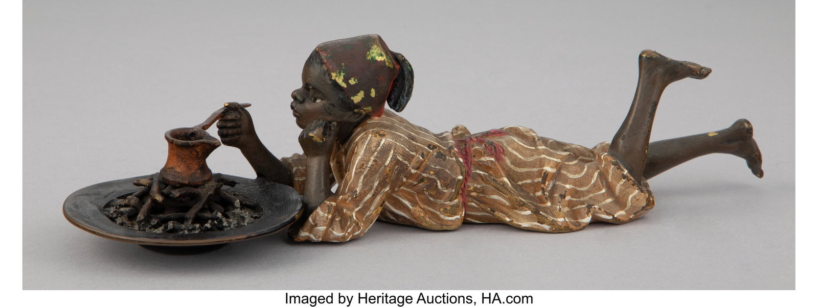 A Franz Bergman Cold Painted Bronze Figure: Litt: A Franz Bergman Cold Painted Bronze Figure: Little Boy Cooking Over Fire, early 20th century Marks: (B-amphora) 2 x 2-3/8 x 7-1/4 inches (5.1 x 6&period