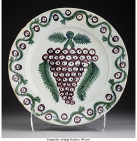 61248: An English Delftware Charger with Grape Motif, c