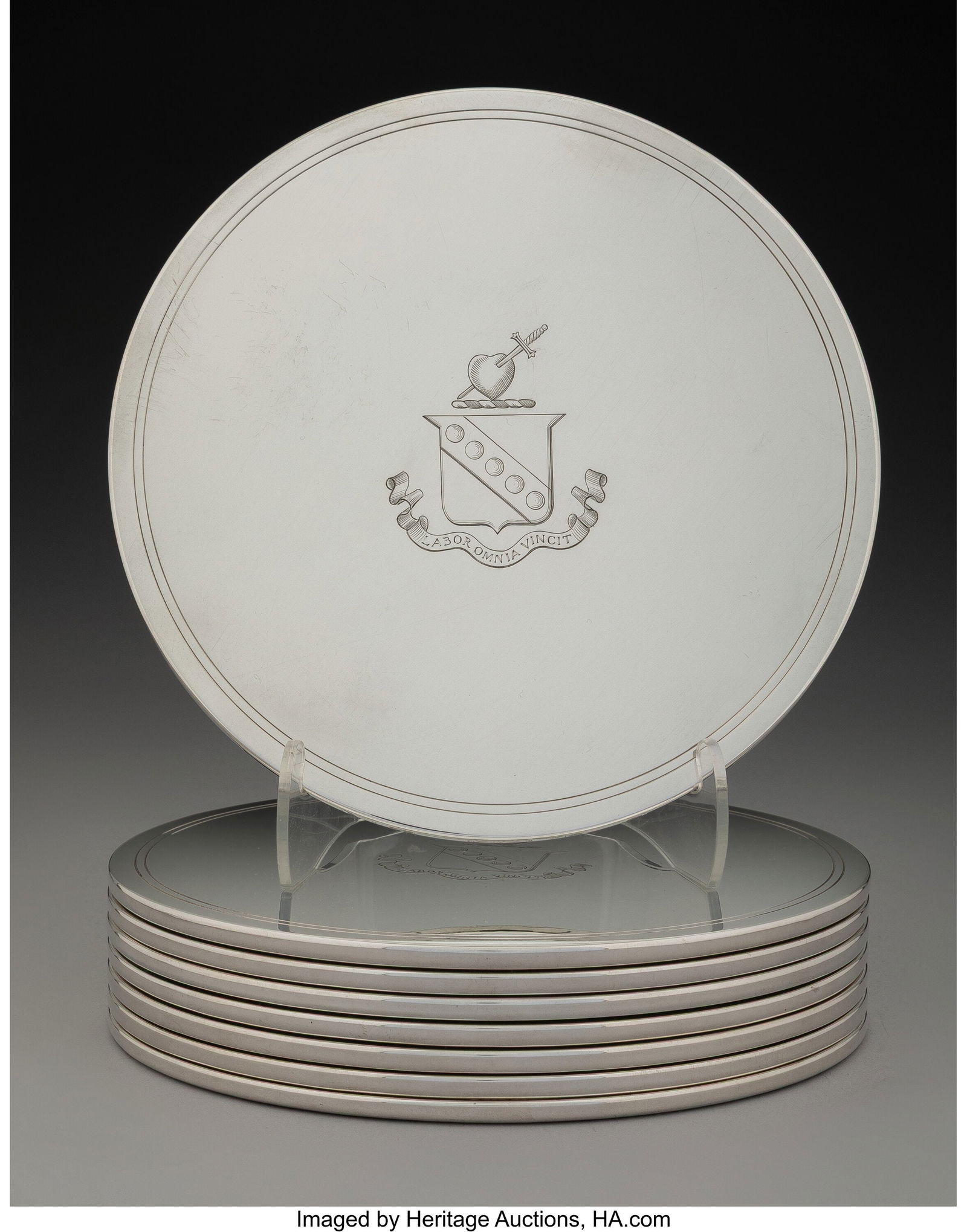 A Set of Eight Tessiers Ltd. Weighted Silver Tri: A Set of Eight Tessiers Ltd. Weighted Silver Trivets, London, 1963 Marks: (lion passant), (leopard's head), HP LP, h 8 inches (20.3 cm) (diam., each) The set with a crest and inscription LABOR OMNIA V
