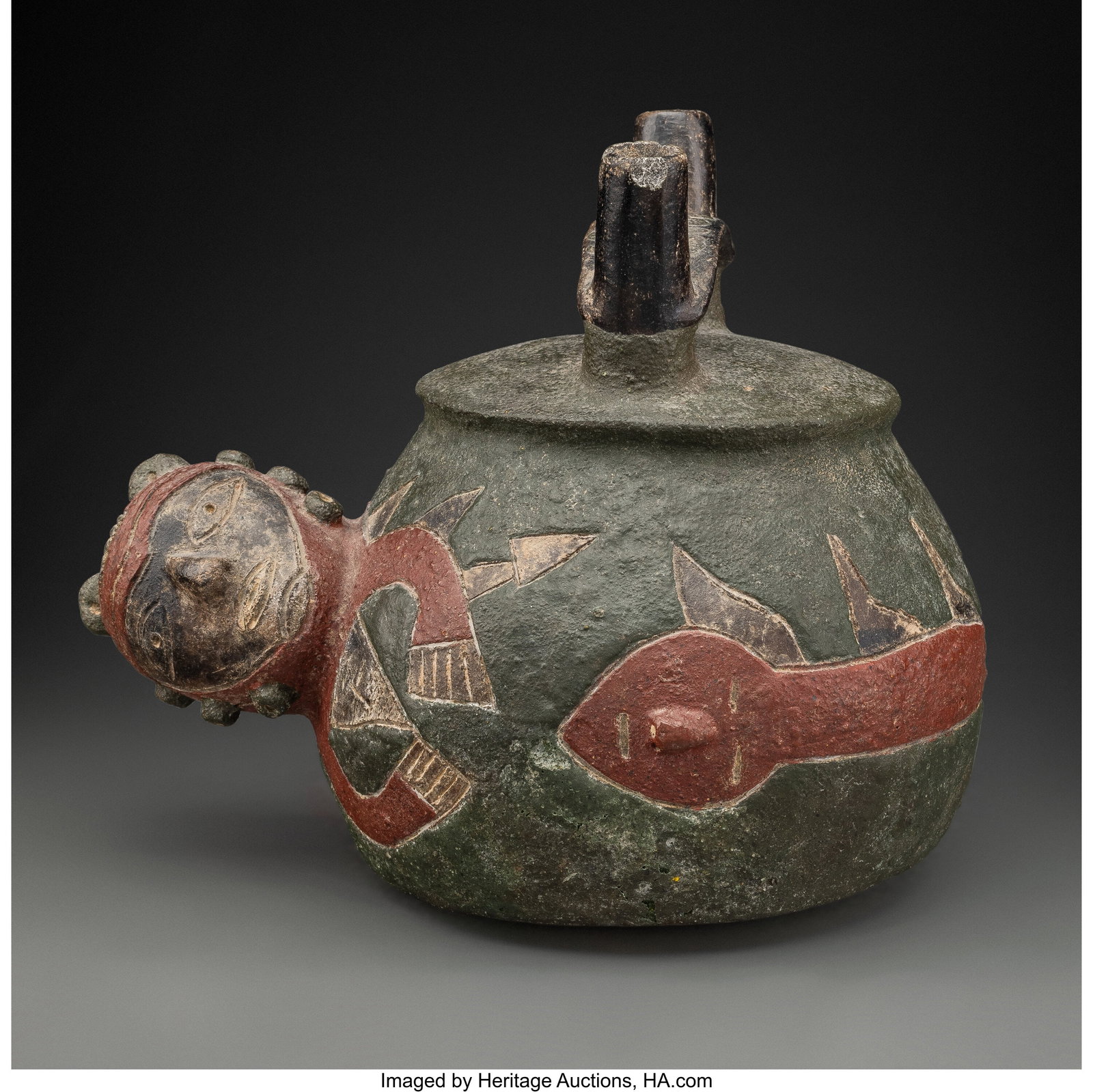 A Paracas Bridge Spout Vessel Peru, c. 700-100: A Paracas Bridge Spout Vessel Peru, c. 700-100 BC A hollow blackware vessel with an incised and painted shamanic shape-shifter with fully modeled head at end of a feline/serpent body&