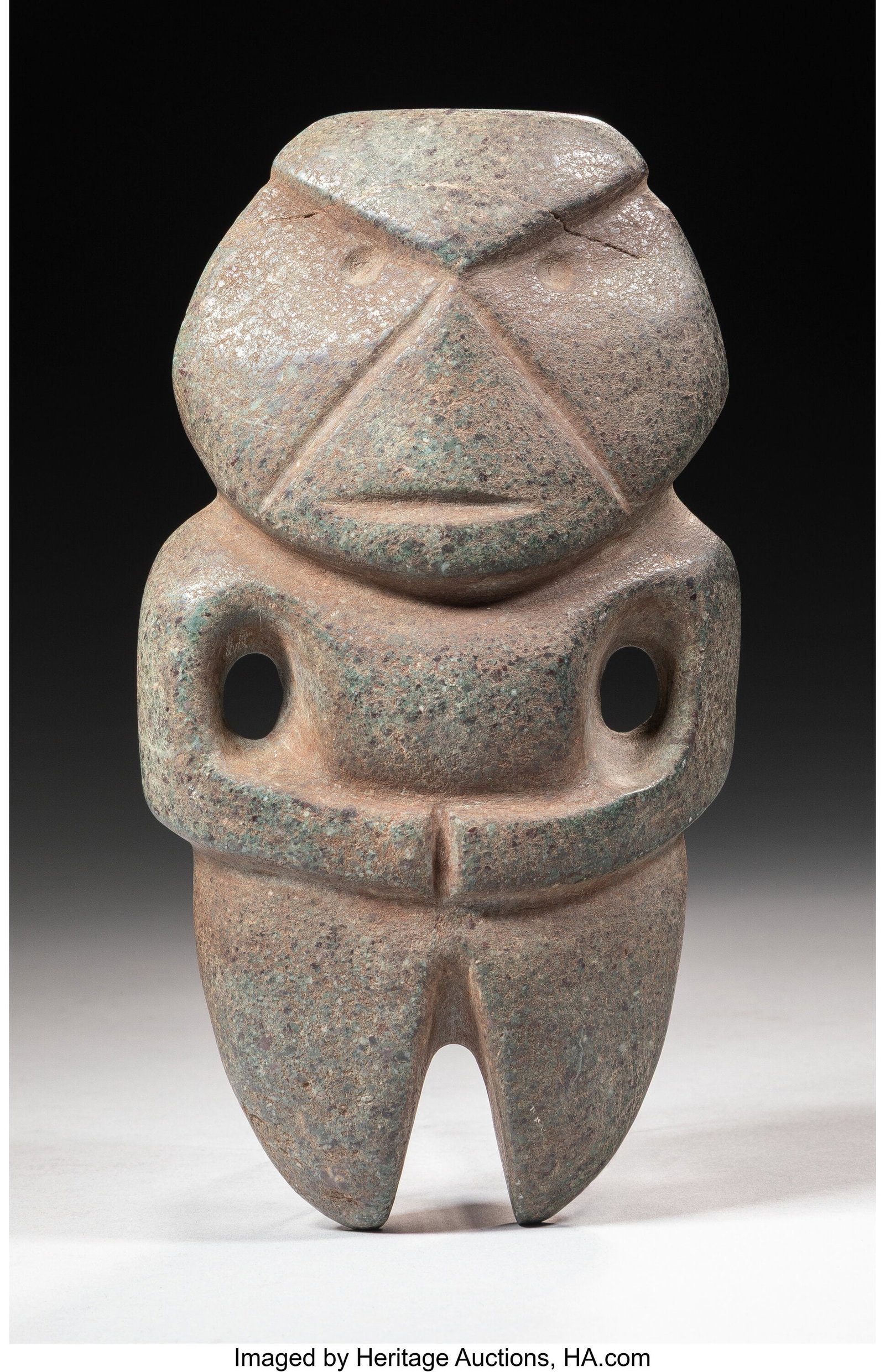 A Mezcala Stone Figure Guerrero, Mexico, c. 40: A Mezcala Stone Figure Guerrero, Mexico, c. 400-100 BC Speckled greenish stone, finely carved and finished, in form of a standing figure with hands to abdomen. Gr