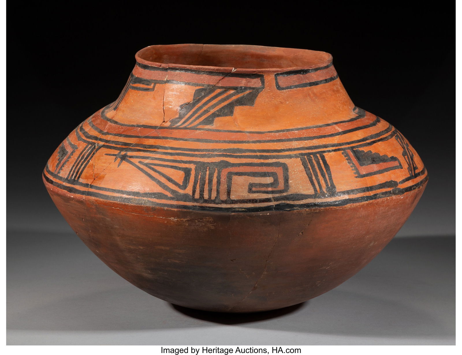 A Rare Rio Grande Polychrome Glazeware Jar c.: A Rare Rio Grande Polychrome Glazeware Jar c. 1300 - 1400 AD Of carinated form rising to a wide neck. Painted in red and black, with two registers of angular and stepped motifs enc
