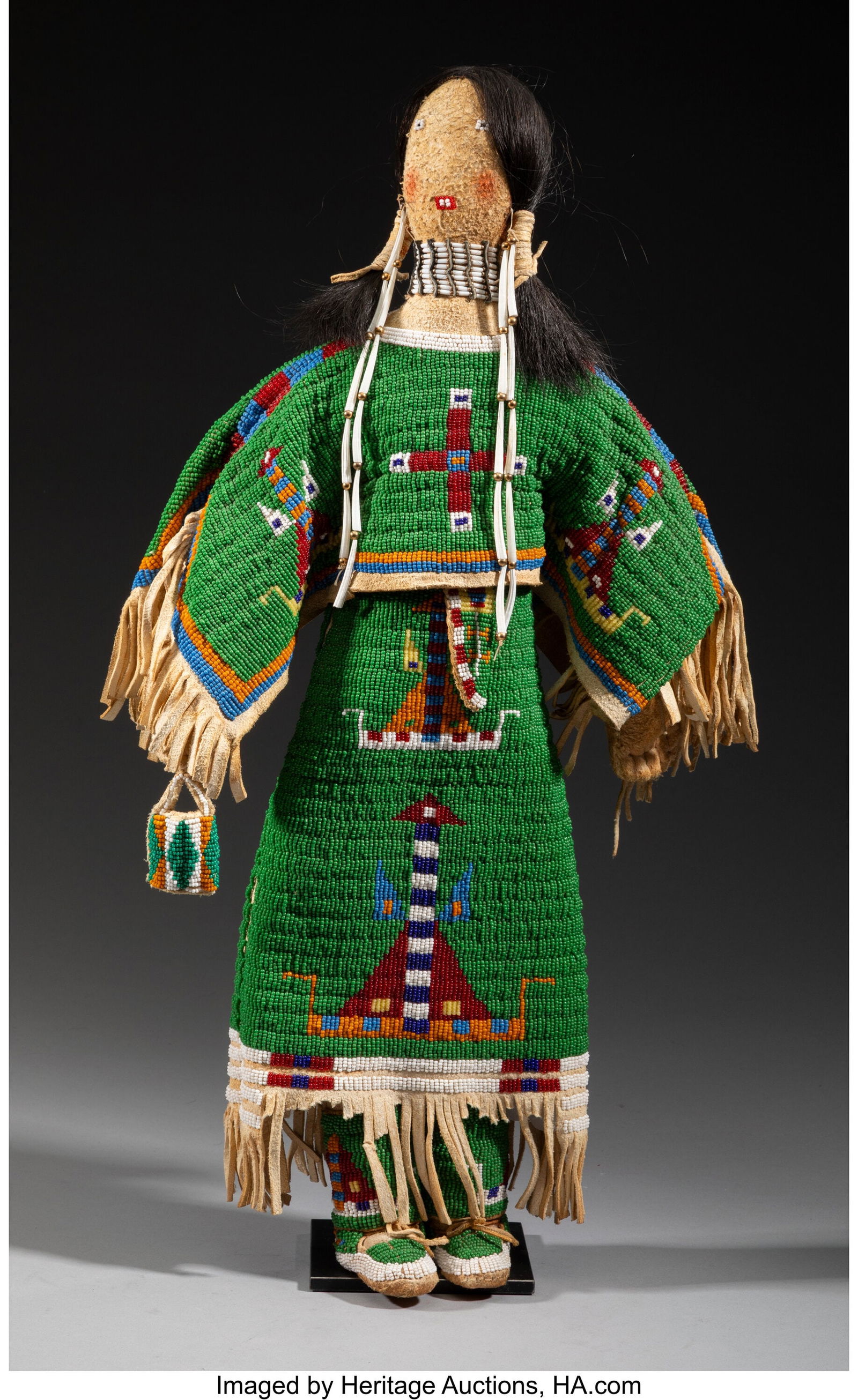 A Contemporary Cheyenne Beaded Hide Female Doll: A Contemporary Cheyenne Beaded Hide Female Doll Smokey Dorr Composed of hide, with beaded facial features and pig tail coiffure. Wearing a dress, leggings, and moccasins decor