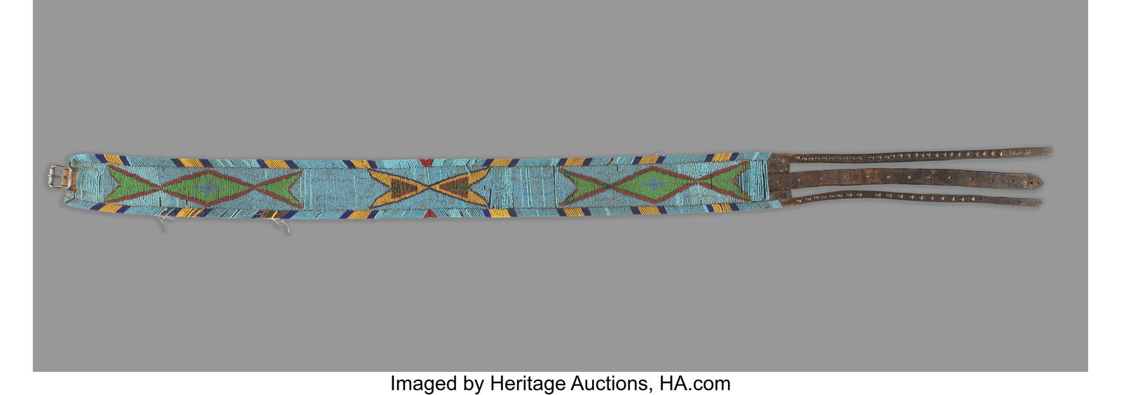 A Blackfeet Beaded Leather Panel Belt c. 1890: A Blackfeet Beaded Leather Panel Belt c. 1890 The broad commercial leather belt beaded along its length with large geometric devices stitched in metal and glass seed beads, finished with