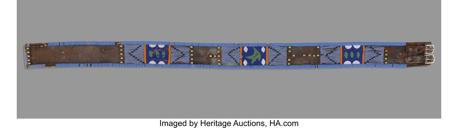 A Blackfoot Beaded Leather Panel Belt c. 1890: A Blackfoot Beaded Leather Panel Belt c. 1890 Composed of commercial leather with panels of small faceted glass seed beads alternating with small brass tacks. Fitted with metal buckles a