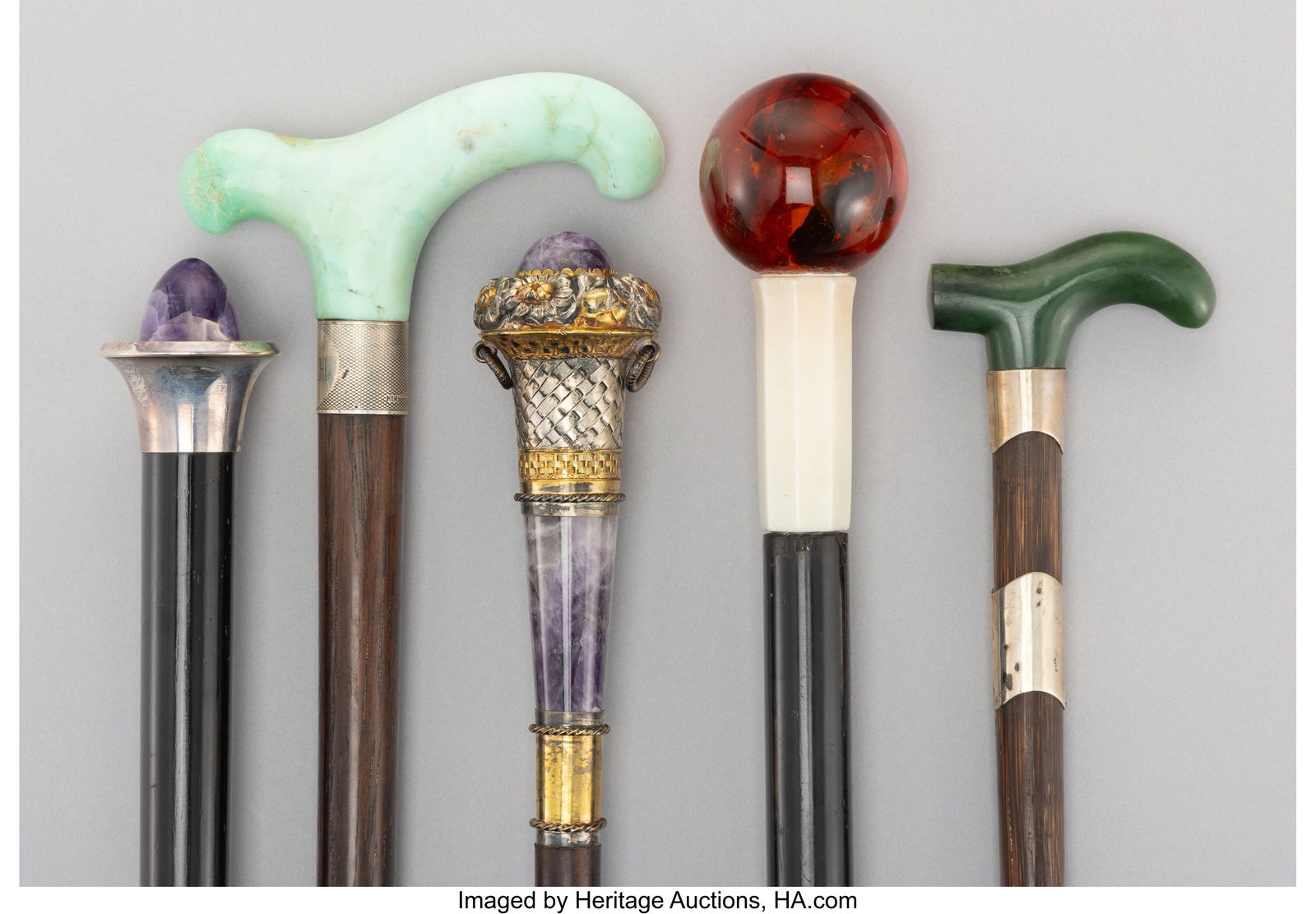 Five Amber, Amethyst, Hardstone, Silver-Mounted,: Five Amber, Amethyst, Hardstone, Silver-Mounted, Carved Wood, and Bamboo Canes, circa 1900 Marks to one: (effaced), (crescent)&comma