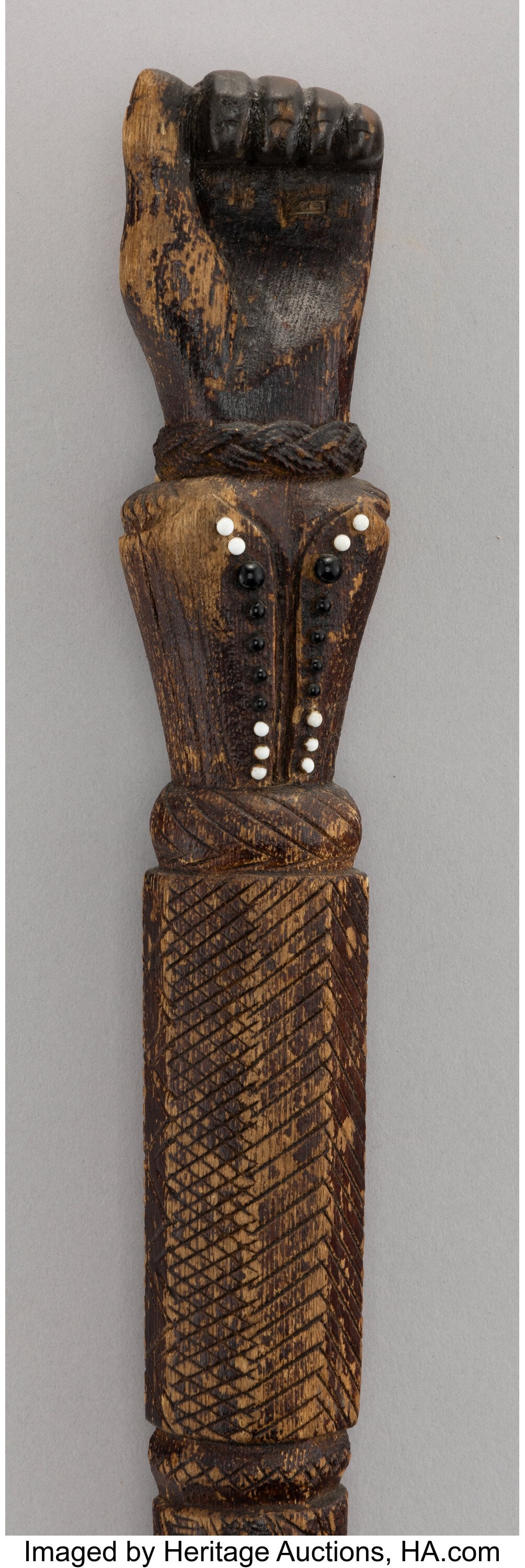 A Carved Wood Cane with a Hand-Shaped Handle and: A Carved Wood Cane with a Hand-Shaped Handle and a Bird Foot Ferrule 35-1/2 x 2-1/8 inches (90.2 x 5.4 cm) HID03101062020 © 2026 Heritage Auctions | All Right
