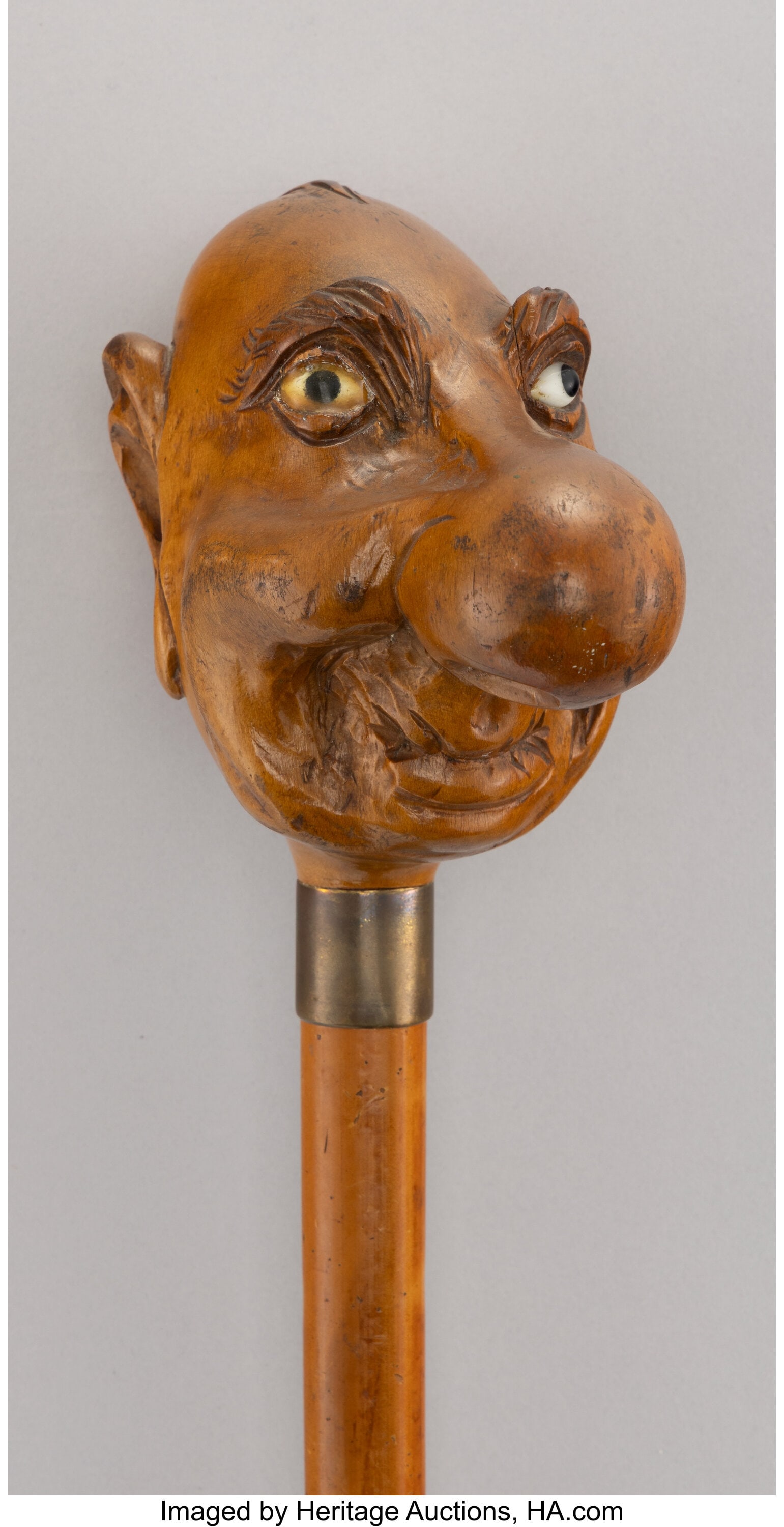 A Carved Wood Figural Cane 36-1/2 x 3-7/8 inches: A Carved Wood Figural Cane 36-1/2 x 3-7/8 inches (92.7 x 9.8 cm) HID03101062020 © 2026 Heritage Auctions | All Rights Reserved www.HA.com/Te
